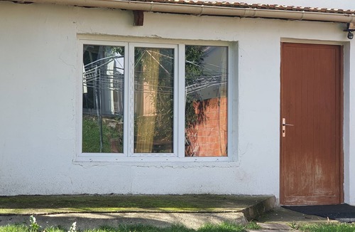 Les Luats Apartment | Pleasant outbuilding in front of a garden in a quiet area