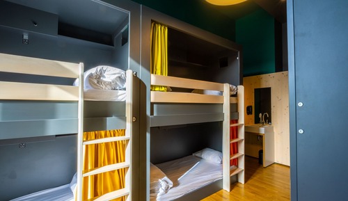 Bed in 6 bed male room with shared bath room.